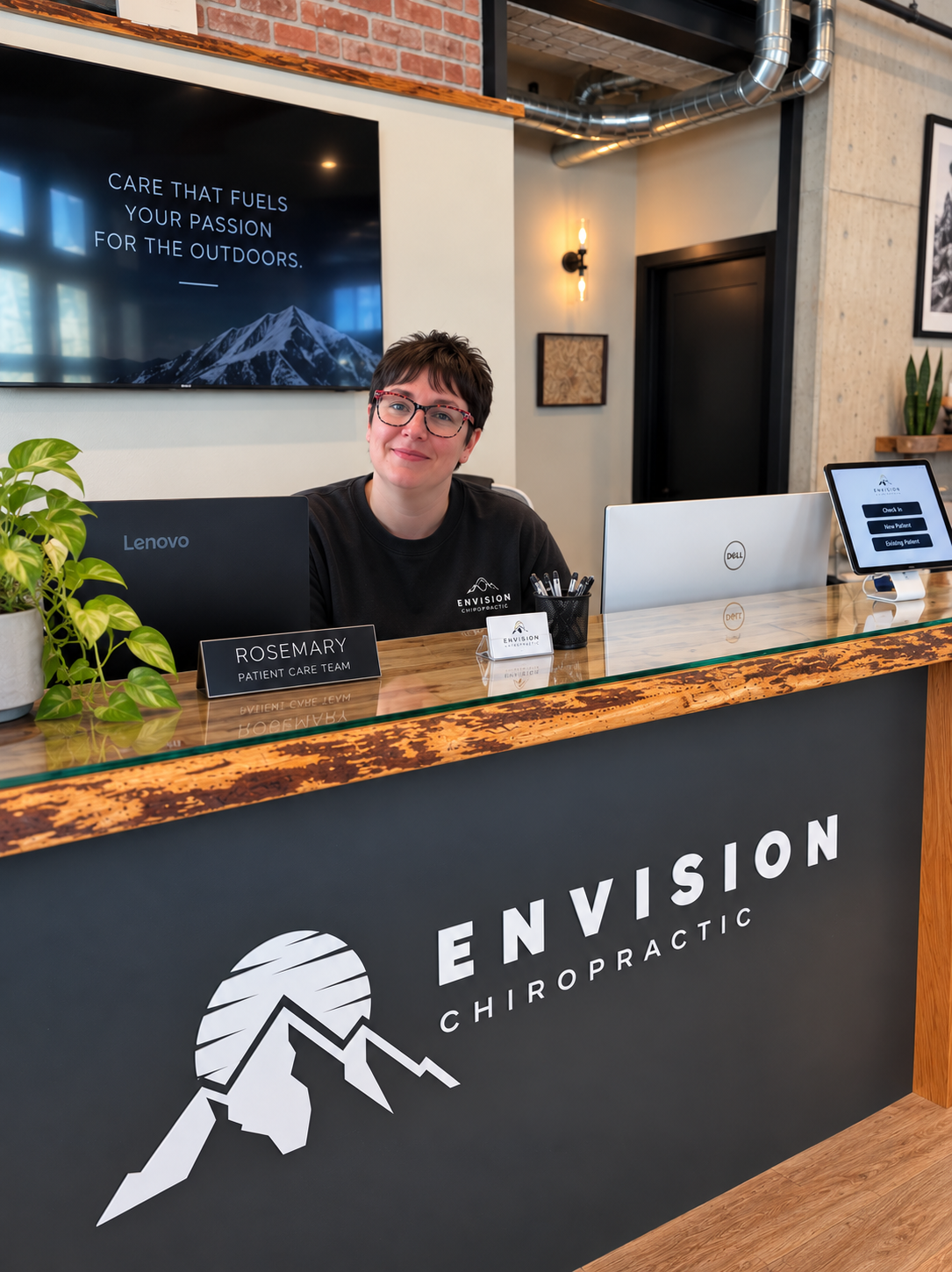 Rosemary welcoming patients at the Envision Chiropractic front desk in Bellingham, WA